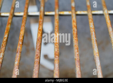 Rusted metal grill bars pictured vertically showing signs of deterioration Stock Photo