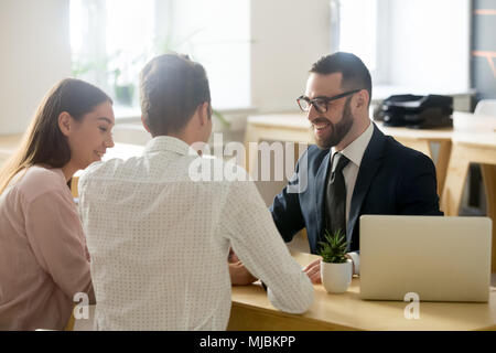 Friendly lawyer or financial advisor in suit consulting young co Stock Photo