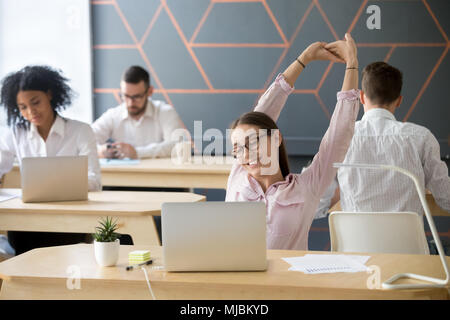 Millennial employee stretching taking break from computer work f Stock Photo