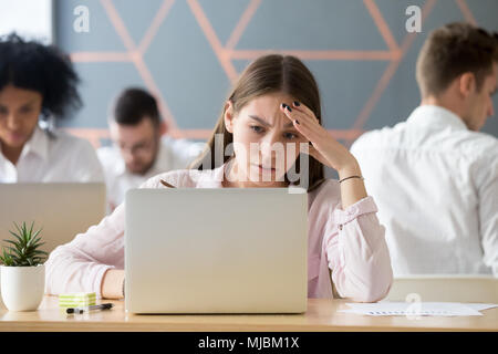 Frustrated stressed woman upset about online problem looking at  Stock Photo