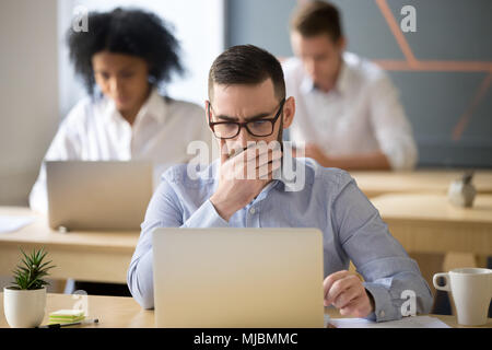 Focused businessman solving online problem working on laptop in  Stock Photo