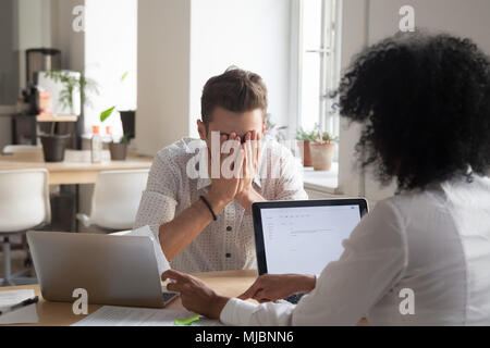 Frustrated employee stressed by dismissal notice being scolded b Stock Photo