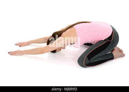 Woman exercising yoga indoor-Hare pose/ Shashankasana Stock Photo | Adobe  Stock
