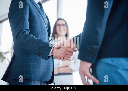 Two confident business man shaking hands during a meeting in the office, success, dealing, greeting and partner concept. Stock Photo