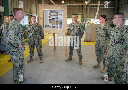180430-N-PE825-0045 NAVAL STATION ROTA, Spain (April 30, 2018) –Capt. Cameron Geertsema, commander, 22nd Naval Construction Regiment, left, speaks with Seabees assigned to Naval Mobile Construction Battalion (NMCB) 11 during a tour of Camp Mitchell, Naval Station Rota, Spain, April 30, 2018. NMCB-11 is forward-deployed to execute construction, humanitarian and foreign assistance, special operations combat service support, and theater security cooperation in the U.S. 6th Fleet area of operations. (U.S. Navy photo by Mass Communication Specialist 1st Class Collin Turner/Released) Stock Photo