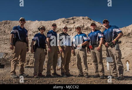 Members of the Air Force Action Shooting Team pose for a portrait in between stages of the United States Practical Shooting Association’s Multigun National Championship in Boulder City, Nevada, April 21, 2018. Members of the Air Force team finished 4th and 12th out of 63 competitors in the Open Division, and 18th, 28th, 55th and 81st out of 166 competitors in the Tactical Division. (U.S. Air Force photo by Senior Airman Kevin Tanenbaum) Stock Photo