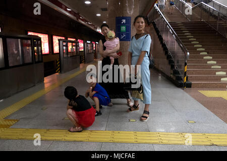 Chinese family waiting for subway train in underground station in Beijing, China, Asia Stock Photo