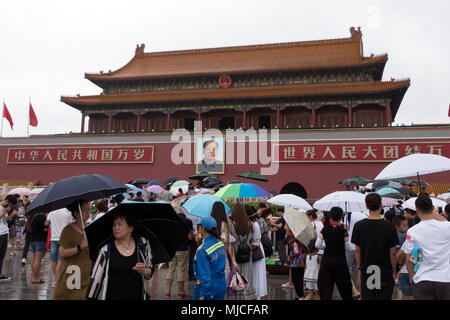 Crowd, people and Chinese tourists entering the gate of the Forbidden City in Beijing, China, Asia. Travel in the rain, holidays and tourism Stock Photo