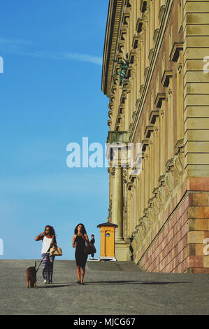 Stockholm, Sweden - July 2014: People walking by the Royal Palace of Stockholm, in old town Gamla Stan, Stockholm, Sweden Stock Photo