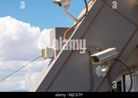 Watching the city life by two security cameras placed on the roof. Stock Photo
