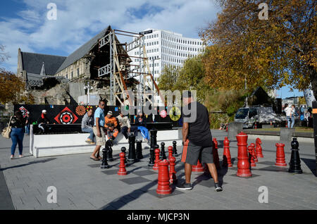 CHRISTCHURCH, NEW ZEALAND, APRIL 20, 2018: A public game of chess continues in the shadow of the iconic Anglican Cathedral in Christchurch, New Zealan Stock Photo