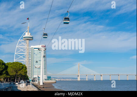 Lisbon, Portugal - Nov 26, 2013 : Lisbon telecabine north station against blue sky with Vasco da Gama bridge in the background Stock Photo