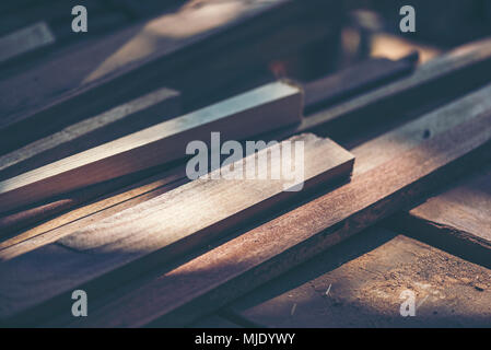 Background image of woodworking workshop: carpenters work table with different tools and wood cutting stand, vintage filter image Stock Photo