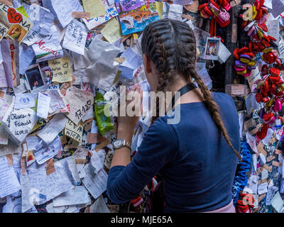 Woman at a wall with good wishes at Juliet's House, Verona, Veneto, Italy, Europe Stock Photo