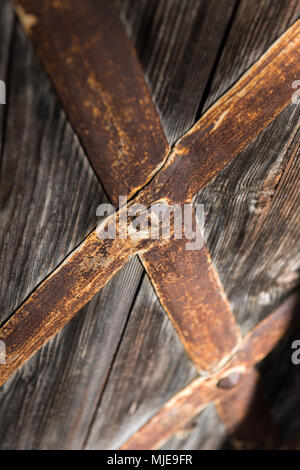rusty hinge on old wooden door, close-up Stock Photo