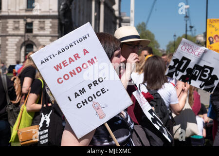 London, UK, 5th May 2018, Members of the Abortion rights group and pro choice members hold a protest in Parliament Square to highlight 50 years since the abortion act came into force and to highlight the options of my body my choice. A woman holds a placard with the words anti abortion?  wear a condom on it. Credit: adrian looby/Alamy Live News