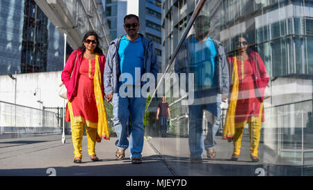 London, UK.  5 May 2018.  UK Weather - Tourists create a vivid reflection as they cross a bridge in Paddington Basin in the warmth of the late afternoon sun.  Even warmer temperatures are expected on Bank Holiday Monday.  Credit: Stephen Chung / Alamy Live News Stock Photo