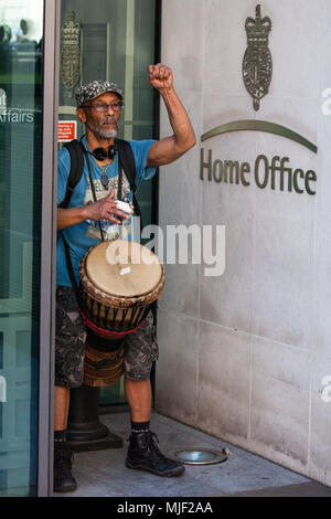 London, UK. 5th May, 2018. A man drums outside the Home Office during a protest by activists from Stand Up To Racism and supporters of the Windrush generation to call for the scrapping of the 2014 Immigration Act. Credit: Mark Kerrison/Alamy Live News