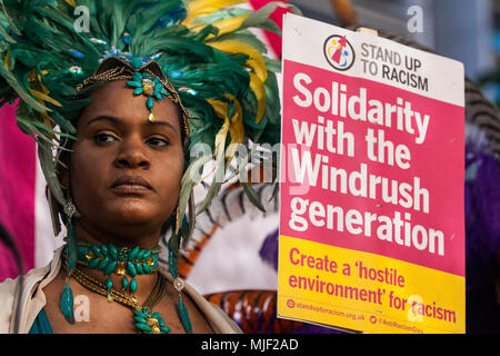 London, UK. 5th May, 2018. A supporter of the Windrush generation in traditional costume protests outside the Home Office to call for the scrapping of the 2014 Immigration Act. Credit: Mark Kerrison/Alamy Live News Stock Photo
