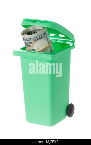One green recycling bin with an open lid and a roll of dollar bills inside isolated on white backlground. Stock Photo