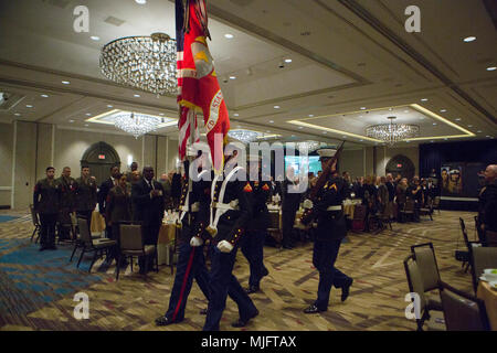 A color guard exits the auditorium after the playing of To The Colors during the opening ceremony of the Marine Corps Association and Foundation's 14th annual Ground Logistics Awards Dinner at the Crystal Gateway Marriott, Arlington, Virginia, March 22, 2018. The dinner provides the formal opportunity to recognize the professional achievements of the top performing Marine logisticians and logistics unit of the year for the previous year. (U.S. Marine Corps Stock Photo
