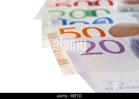 Close-up with selected focus of Swedish banknotes on white background. Stock Photo