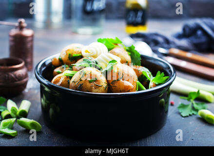boiled potato with fresh greens and butter Stock Photo