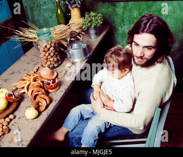 modern hipster father with little cute son on wooden country green kitchen, eating organic food, lifestyle people concept Stock Photo