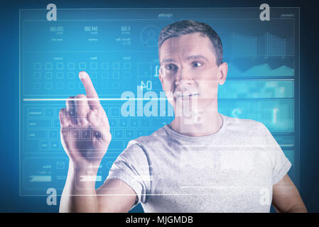 Emotional programmer looking impressed while working with his new equipment Stock Photo