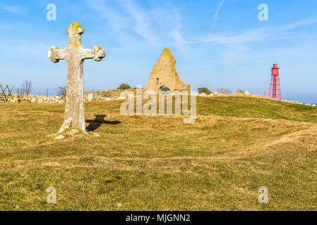 Kapelludden on Oland, Sweden. Three landmarks and also travel attractions. A large stone crucifix, saint Britas chapel ruin and behind that a red ligh Stock Photo