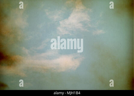 Sky, fog, and clouds on a textured, vintage paper background with grunge stains Stock Photo