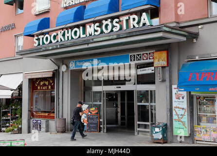 Stockholm, Sweden - July 28, 2016: A person walks towards the entrance of Roslagsbanan station building at station Stockholm East (Stockholms Ostra). Stock Photo