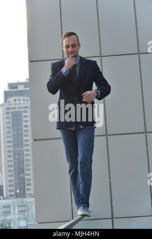brave businessman walking along the abyss edge Stock Photo
