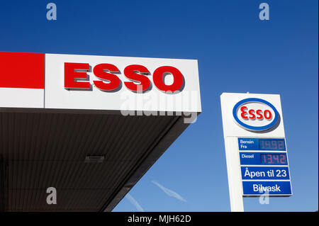 Elverum, Norway - October 3, 2016: Detail of an Esso gasoline service station roof with an advertising sign on a pole with logo and prices. Stock Photo