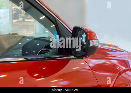 Fragment of the front-side part of a modern passenger car in the sales area. Stock Photo