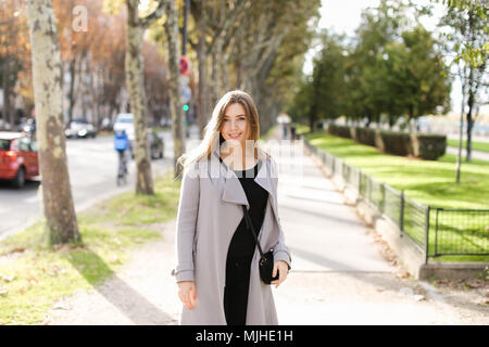 Lady walking in city and enjoying spring weather. Stock Photo