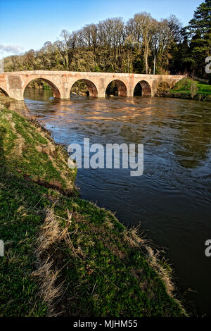 The Wye, at Brobury, is crossed by a long, narrow brick bridge built in 1759, one of the few bridges on the upper reaches of the Wye not swept away in Stock Photo