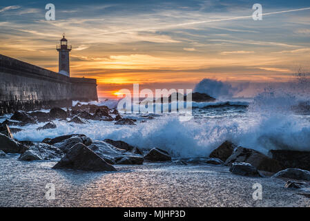 View from Carneiro beach on a Felgueiras Lighthouse during sunset over Atlantic Ocean in Foz do Douro district of Porto city, Portugal Stock Photo