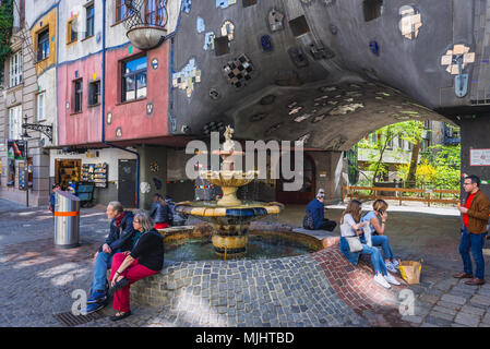 Fountain in front of Hundertwasserhaus - famous apartment house in Vienna, Austria Stock Photo