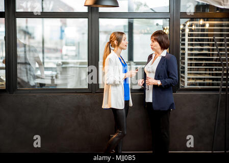 Business women talking in the office of the bakery store Stock Photo