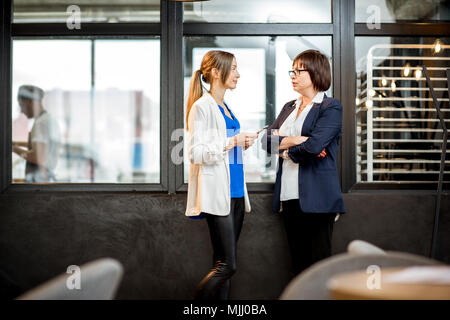Business women talking in the office of the bakery store Stock Photo