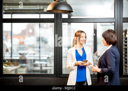 Business women talking in the office of the bakery store Stock Photo