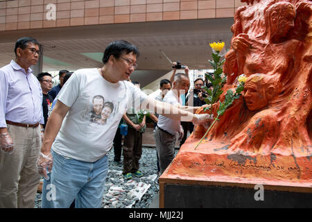 Annual cleaning of Danish artist Jens Galschiot's 'Pillar of Shame' at Hong Kong University Pok Fu Lam Hong Kong. The sculpture is a memorial to the 1 Stock Photo