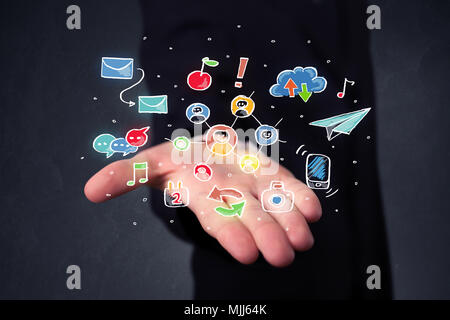 Colorful hand-drawn social media icons in the hands of a businessman Stock Photo