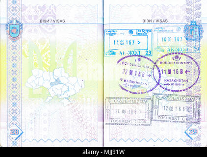 Ukrainian passport with stamps of Kyrgyzstan, Kazakhstan and Uzbekistan. Personal info removed Stock Photo