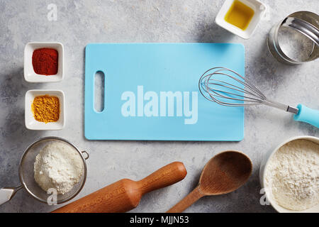 Various baking ingredients and utensils on the kitchen table. Stock Photo