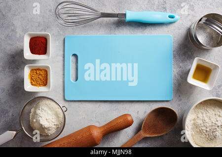 Various baking ingredients and utensils on the kitchen table. Stock Photo