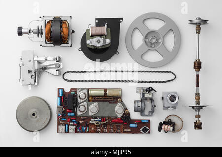 Parts of a vintage film projector well arranged over white background, above view. This is part of a larger series. Stock Photo