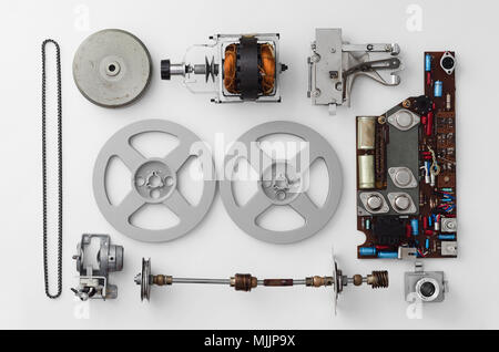 Parts of a vintage film projector well arranged over white background, above view. This is part of a larger series. Stock Photo