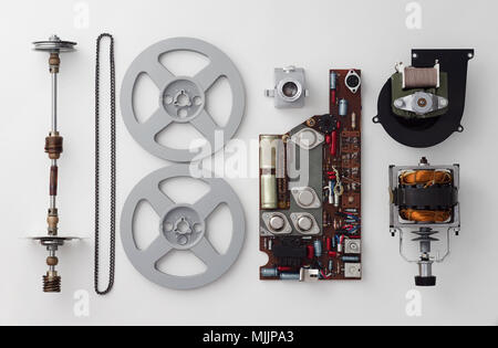 Parts of a vintage film projector well arranged over white background, above view. This is part of a larger series. Stock Photo